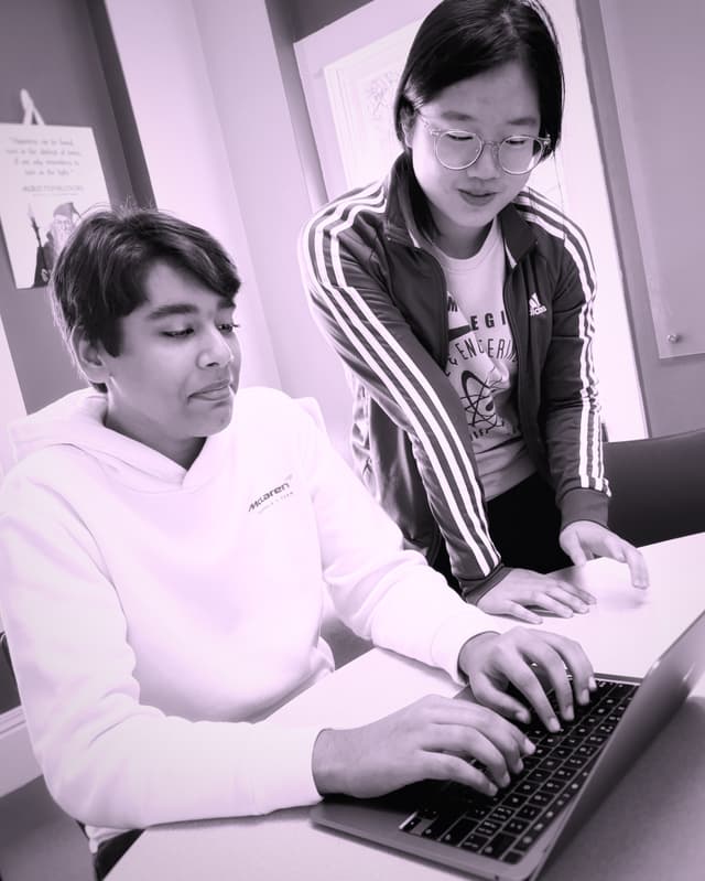 Image of Taj and Kunling, the creators of this web app, coding and discussing